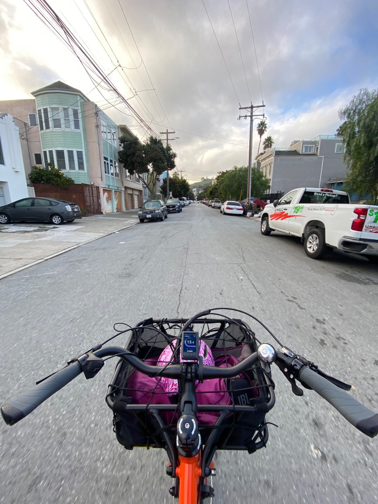 my (rider) POV of no-handing a cargo bike, southbound on Shotwell, in the Mission, SF, U.S.A. Shotwell is a "slow street", through traffic is in theory prohibited but in actuality, only slightly discouraged. The cyclocomputer is registering about 15 miles per hour.