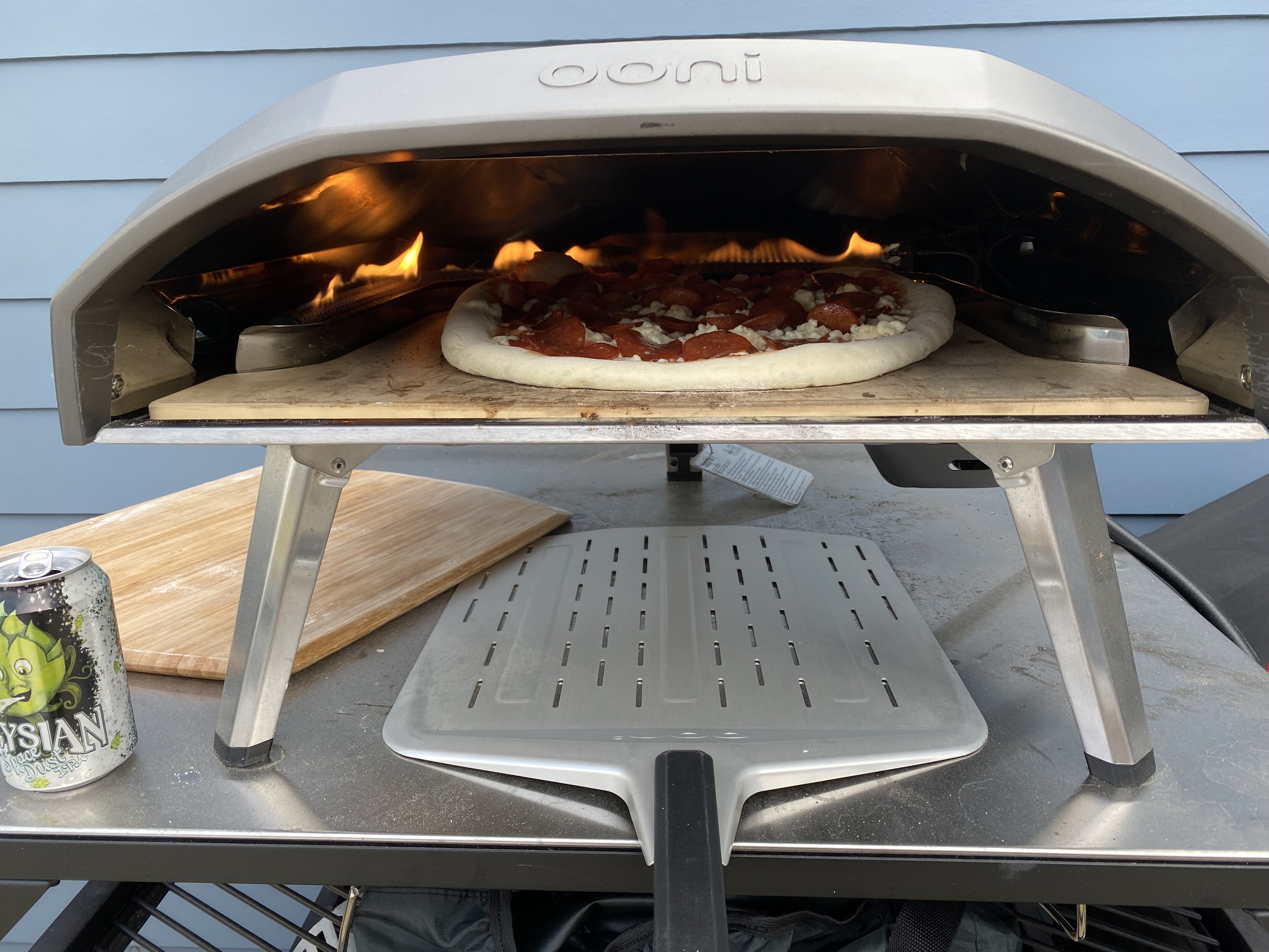 ooni koda gas pizza oven just after launching the pizza into its, about a 15" NY style with pepperoni 