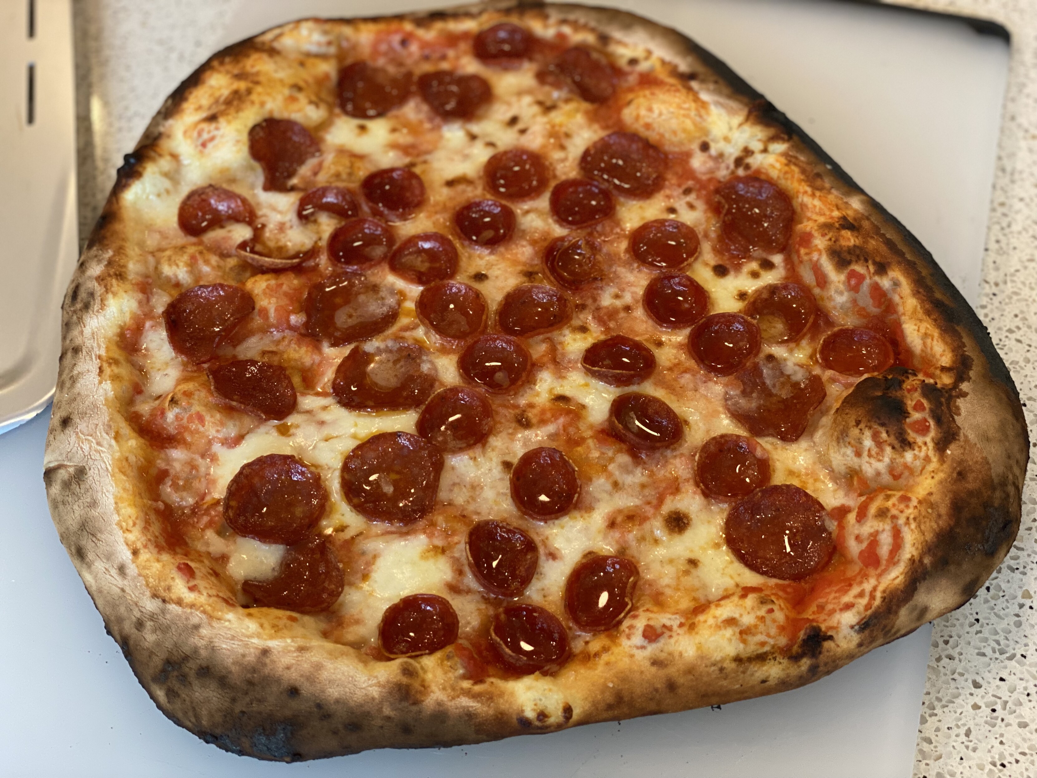 the pizza top down on a cutting board after about a three minute bake