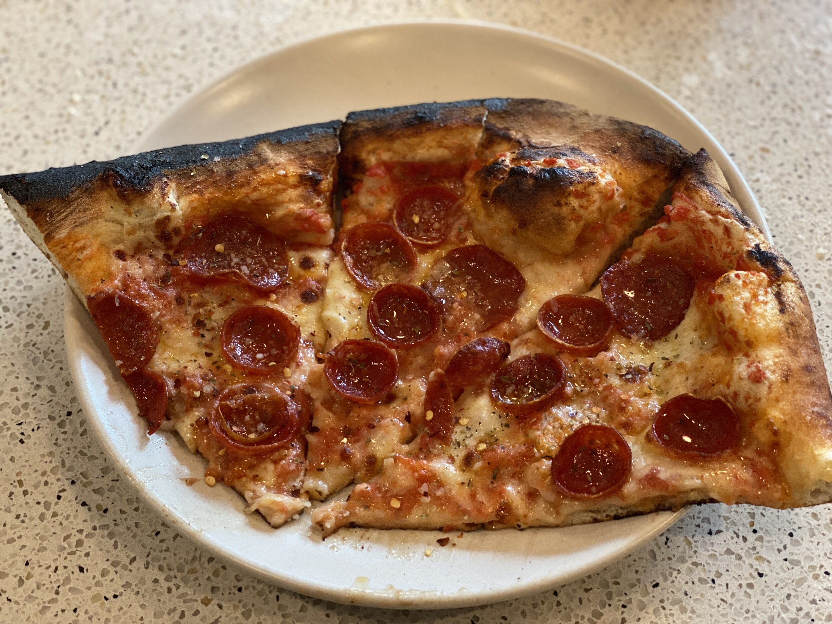 i took the three most burned pieces, topped with pecorino, chili oil, red pepper flakes, and oregano