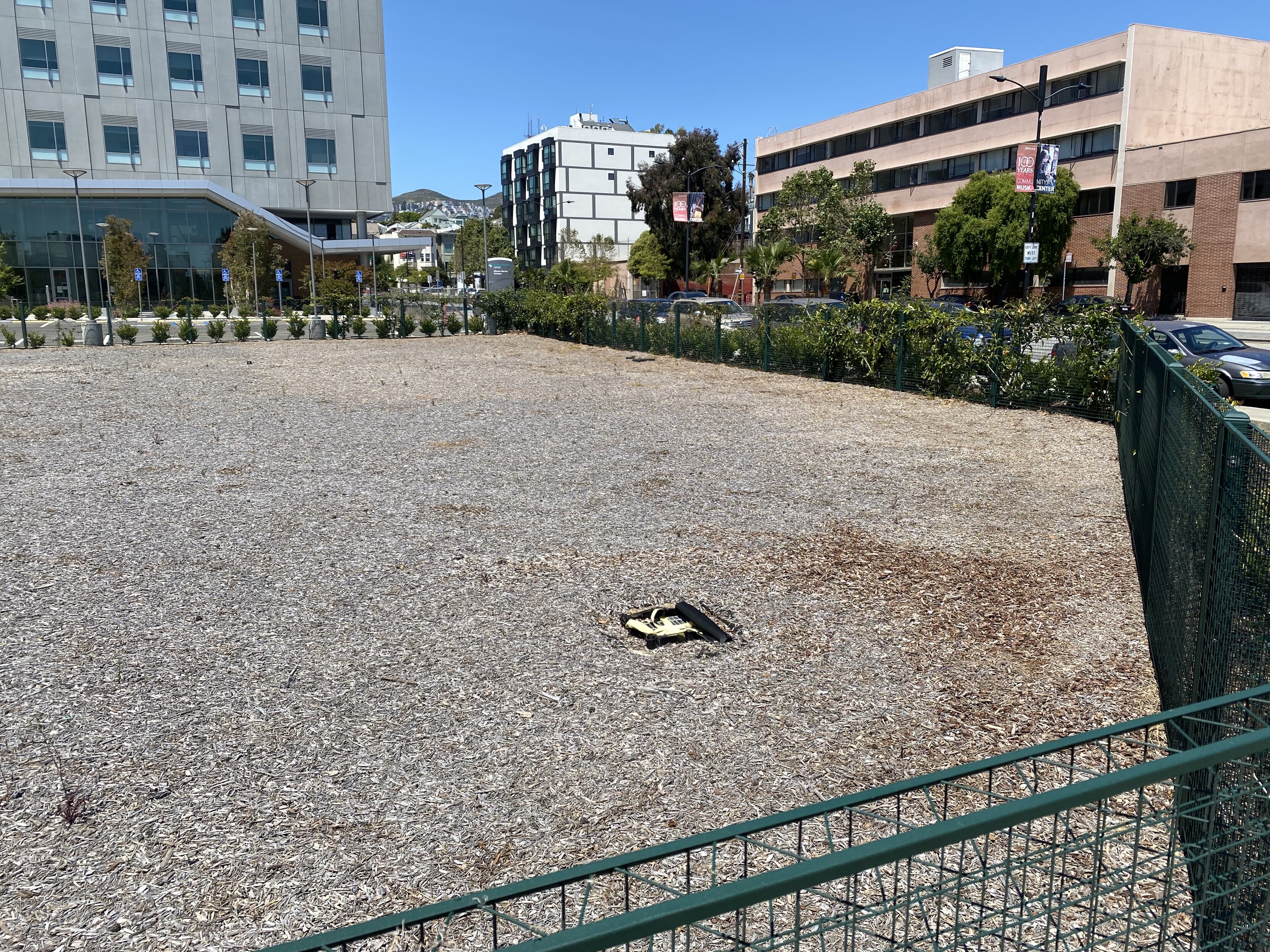 to the right: more of a giant field of mulch where a parking lot might normally be in front of a hospital that wieners kept clearing and covering over again and again and seemed to have given up at "mulch"