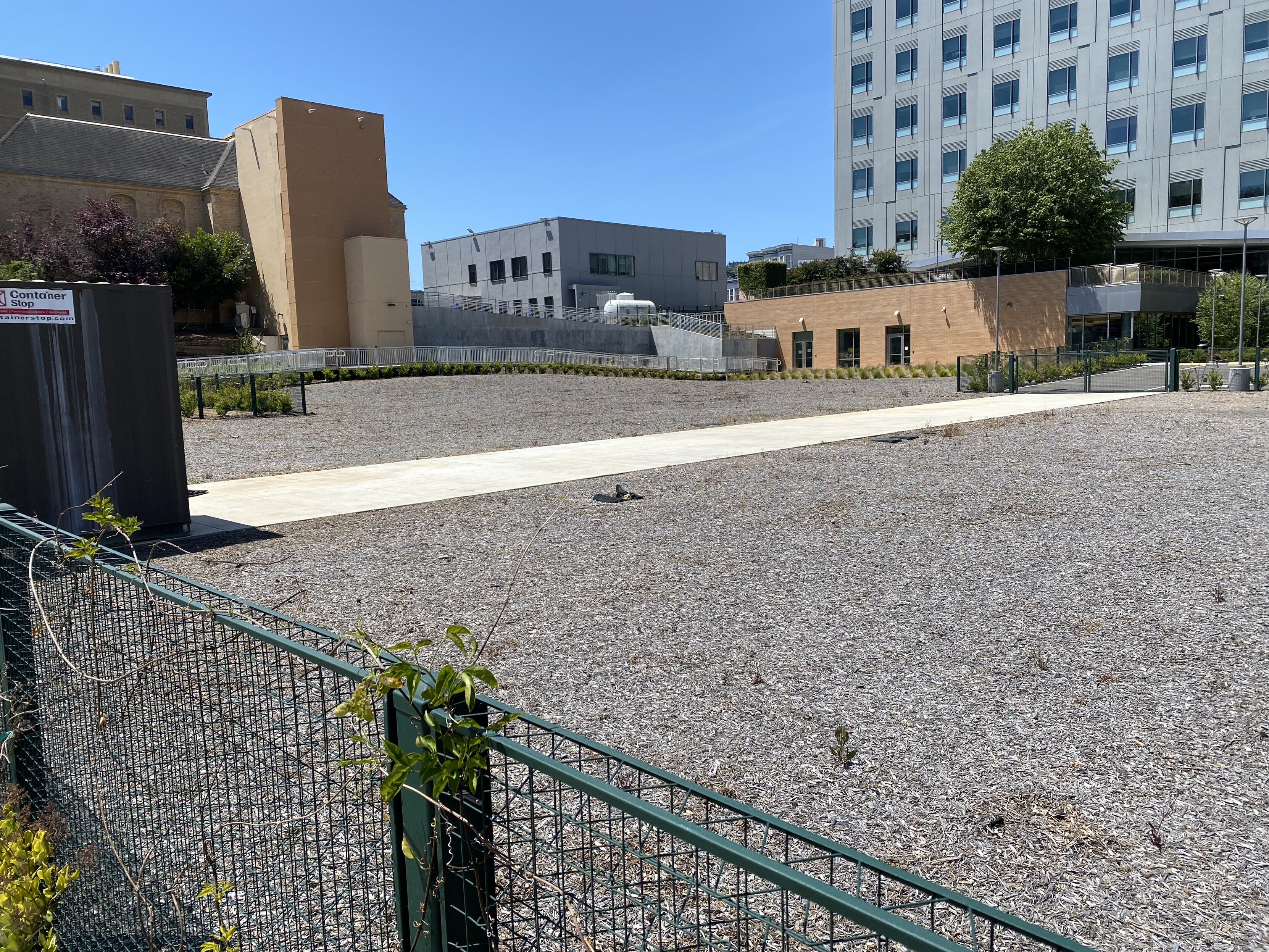 to the left: a giant field of mulch where a parking lot might normally be in front of a hospital that wieners kept clearing and covering over again and again and seemed to have given up at "mulch"