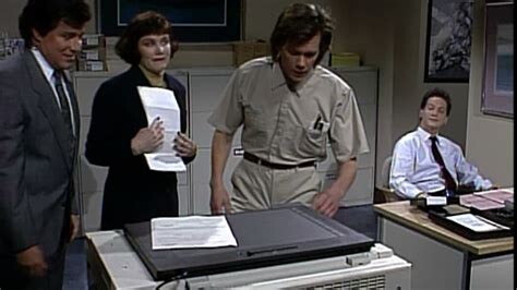 Screen shot of an SNL “Makin’ Copies” sketch featuring Phil Hartman, (RIP), Julia Sweeney, Kevin Bacon, and Rob Schneider