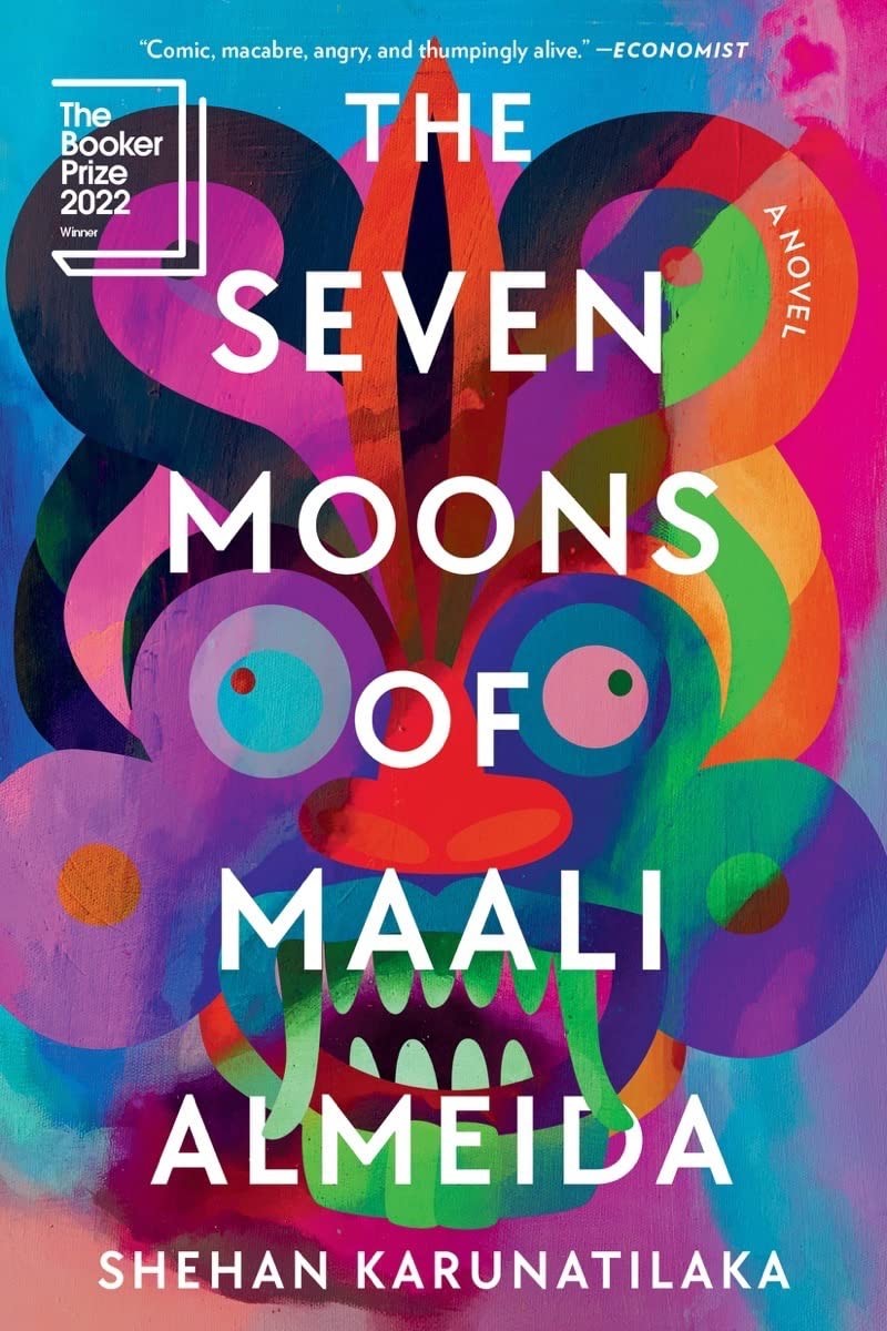 Paperback cover, as I read it, centered all-caps futura lookin' font w/ thep points all alightly rounded in white over a multicolor acrylic painted face in bold geometric cirles and rings and swoops in vibrant colors