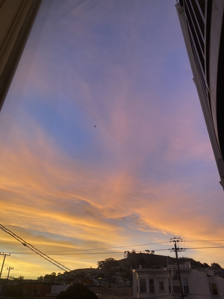 photograph of the sunrise, mostly sky, over bernal, from the mission