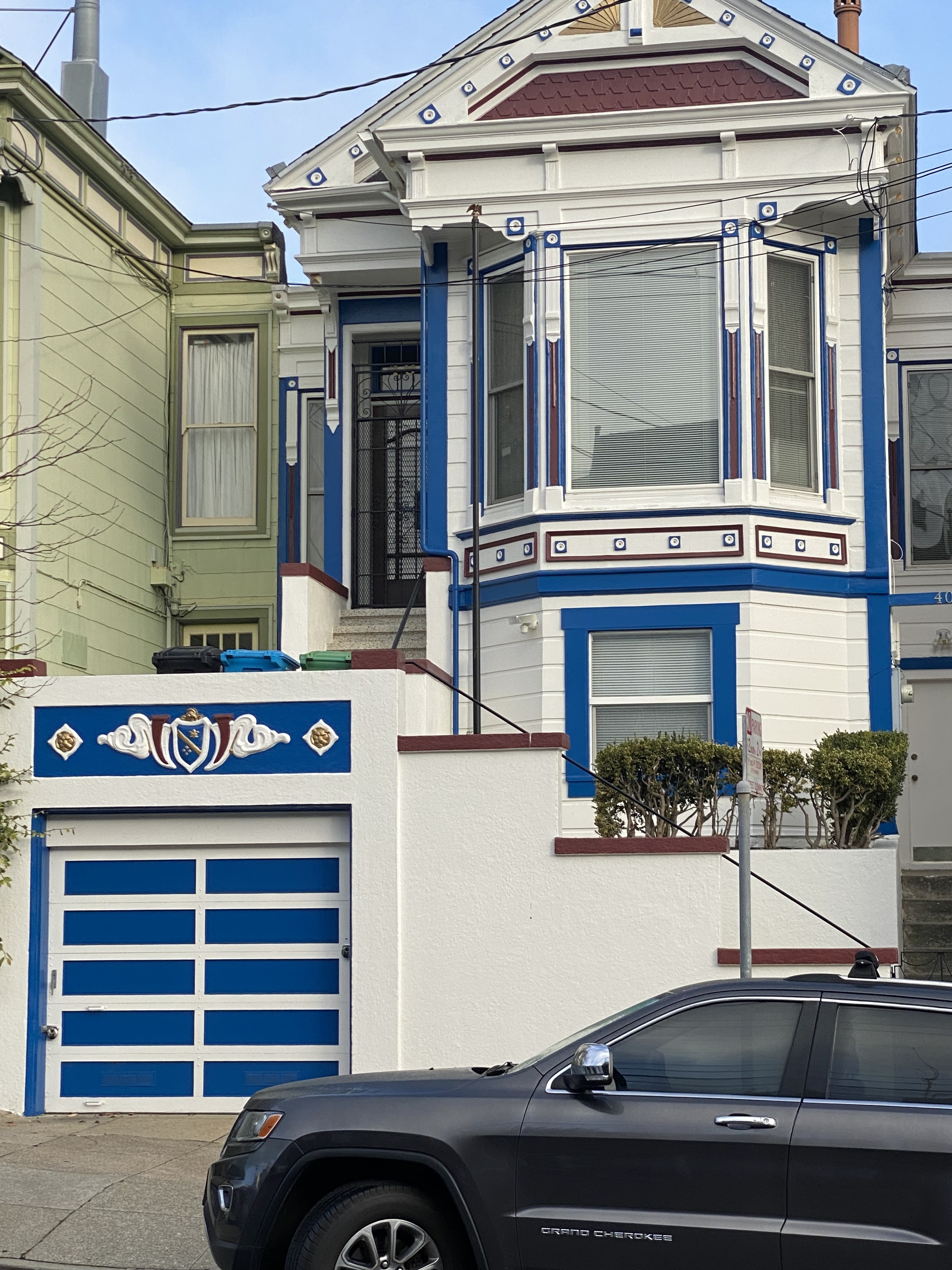 a house in san francisco that is painted white with blue trim