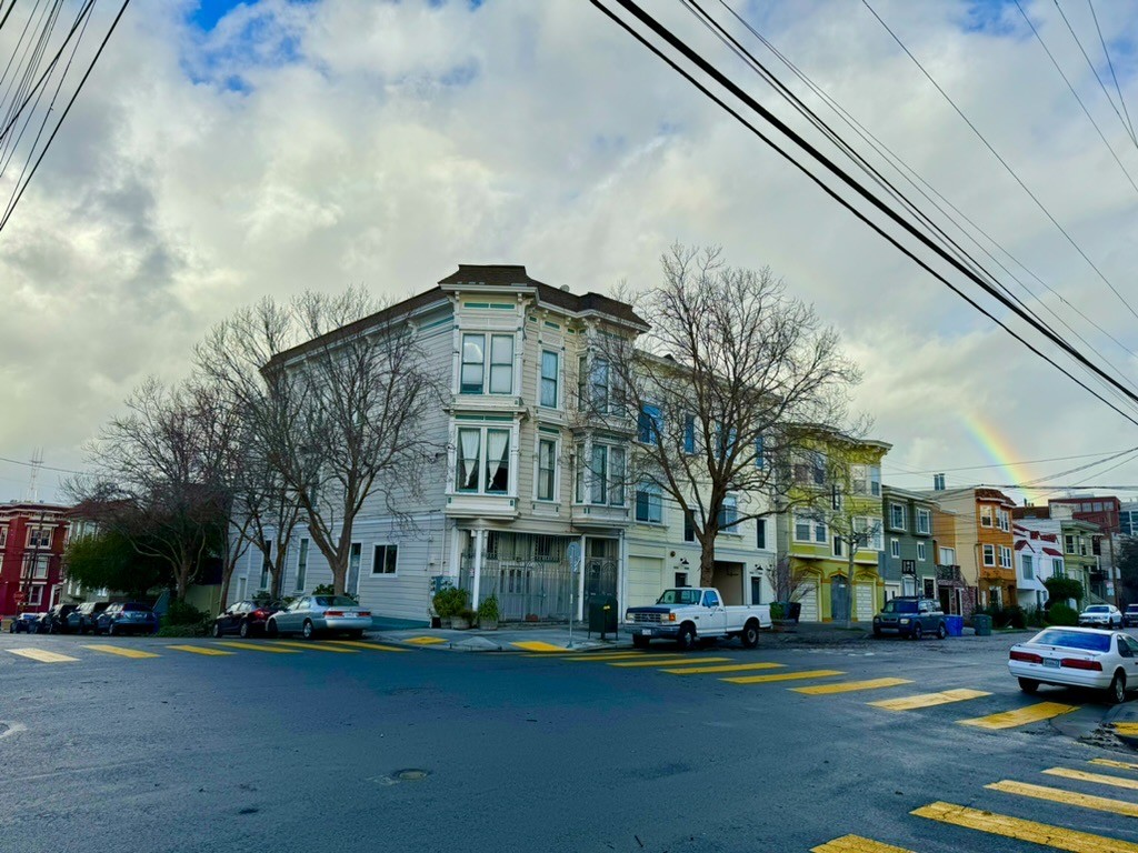 photograph from the corner of 25th Street at San Bruno Street looking northwest at San Bruno, a rainbow rises from the far right in an arc that, if complete, would end on Sutro Tower on the far left, but is only brightly visible for a few degrees of arcI’ve been jacking the saturation on my city shots lately to max it out because it feels more accurate at a glance to what it’s like to look at this stuff irl and also to pop the rainbow. I’m sure this is just a phase I’ll regret like when I used to add vigent to every photo I retouched. Whatever!