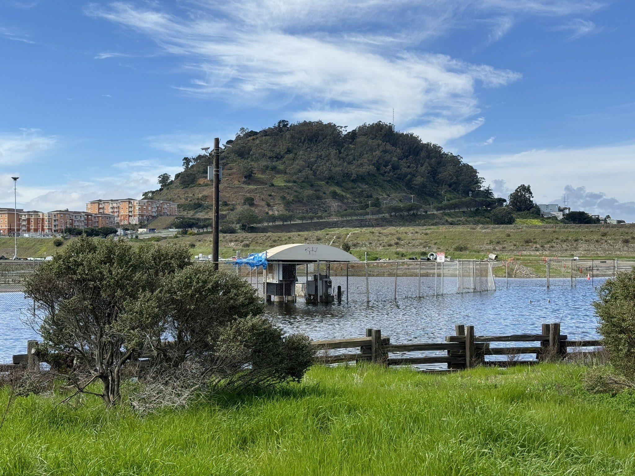 Photograph of Bayview Hill, reversing the second in the series, above from the parking lot of Candlestick Park. Most the actual lot and “Hunter’s Point Expressway” around the hill at this point are just a fenced off lake and are inaccessible.