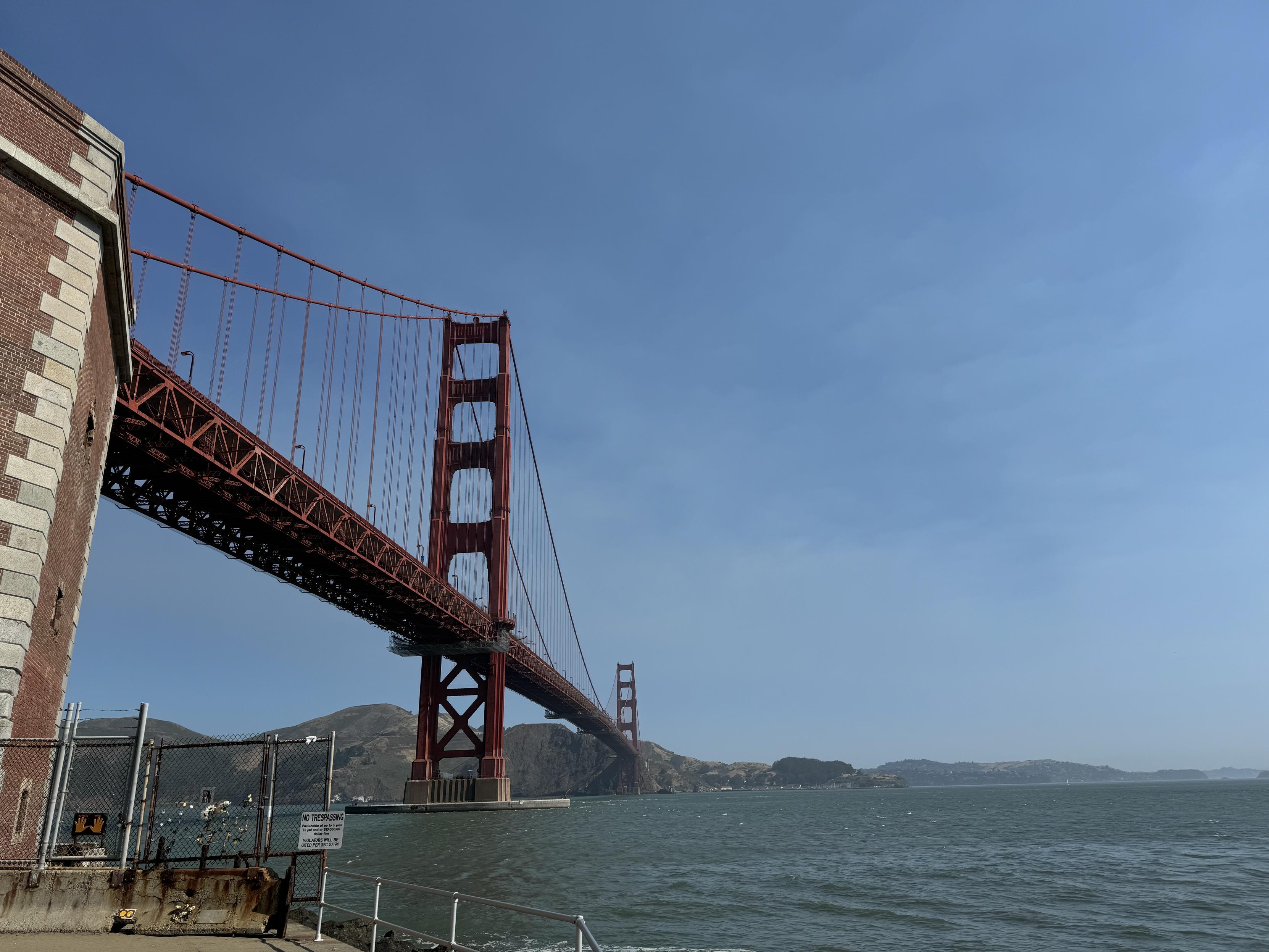 a photo of the golden gate bridge from below, taken from the parking lot at Fort Point, an old military (US Army) base under the southern end of the bridge on the san francisco bay shorline