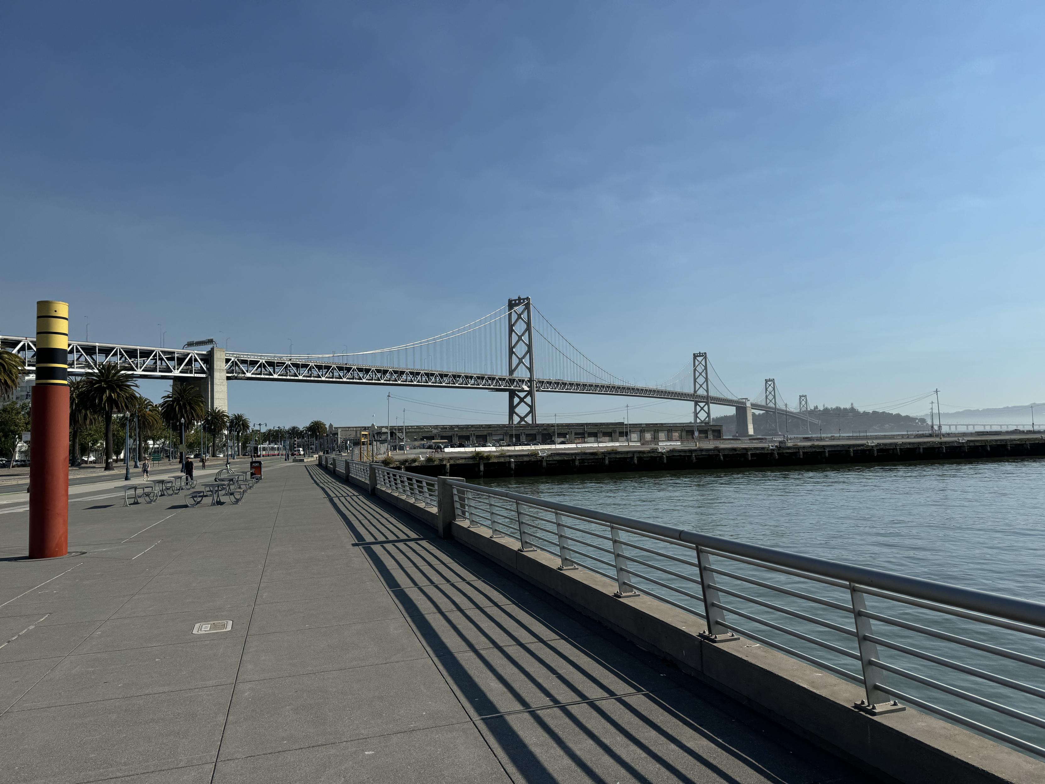 photo of the Bay Bridge to Treasure Island and Oakland beyond, taken from the southern bay shore approach, on a clear sunny day