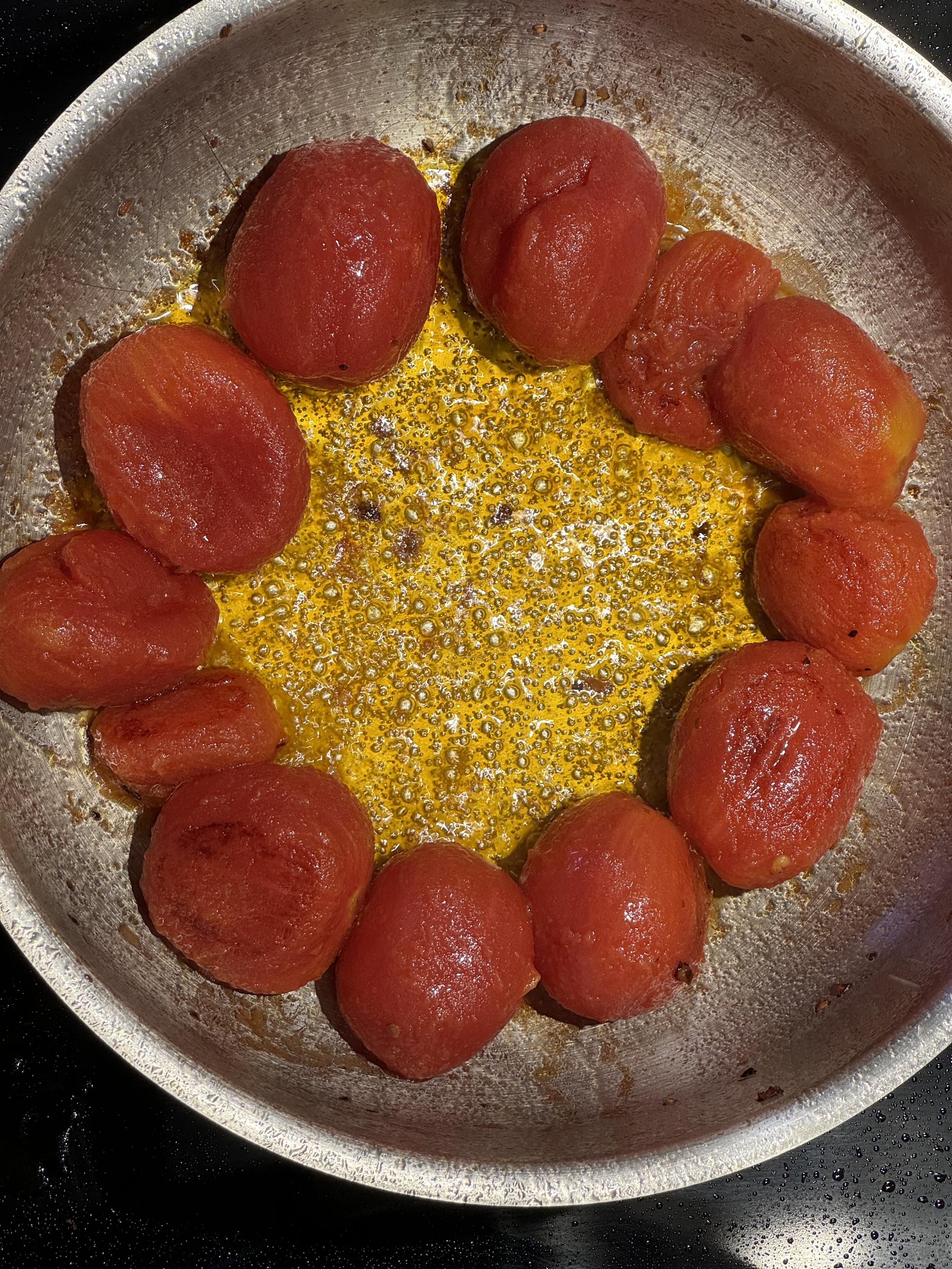 whole peeled san marzanos from a 22 ounce can and a pinches of red pepper and salt flakes frying in a few tablespoons of olive oil. turn to taste, once it’s where you like it, carefully use a wire potato masher or bladed dough cutter to break up the tomatoes, reduce heat to a simmer