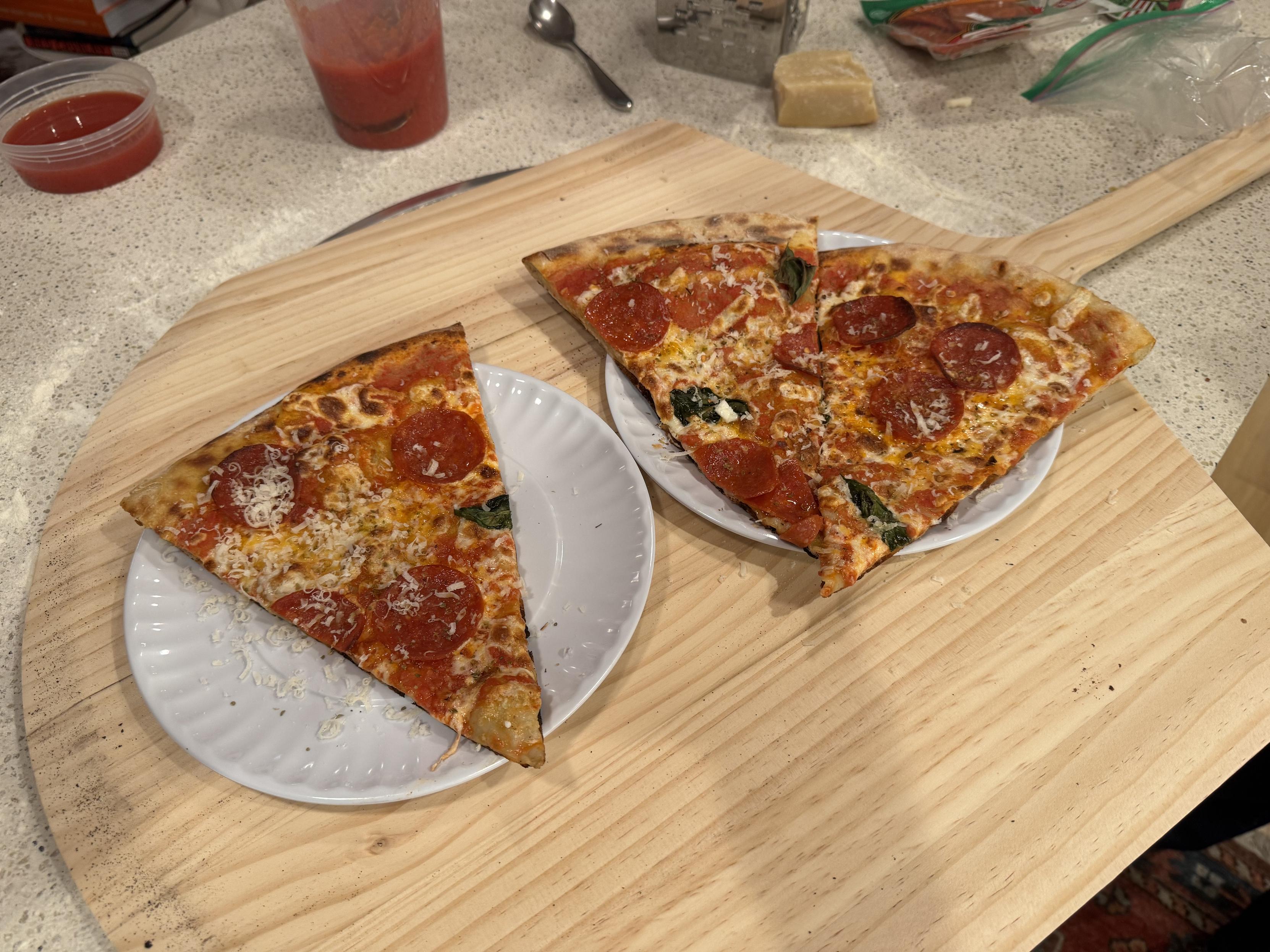 photograph of one slice on a paper plate and two slices on a second paper plate, both on the peel(the paper plates are actually melamine and we re-use them every friday for pizza night because it sets the vibes correctly)