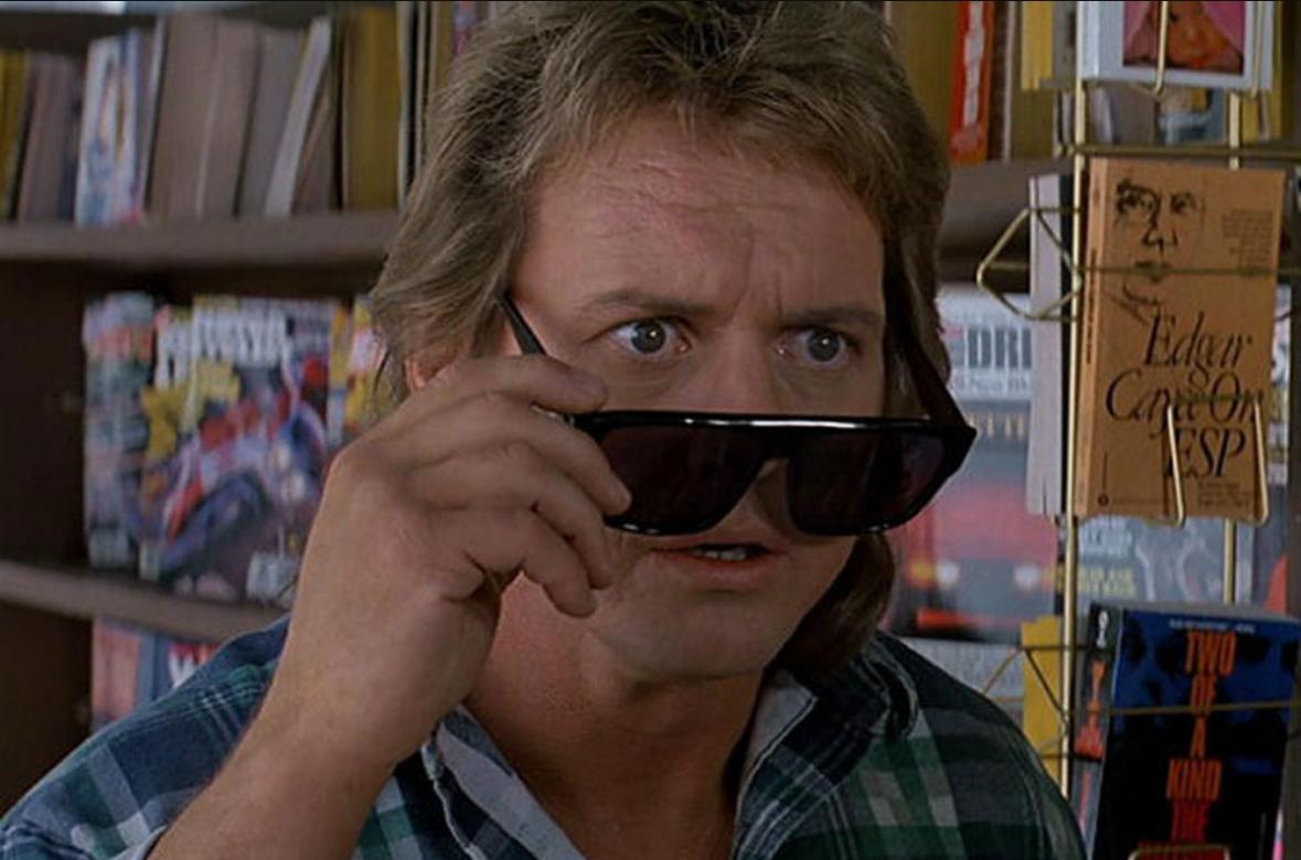 screen grab of roddy popper lowering the sunglasses in They Live