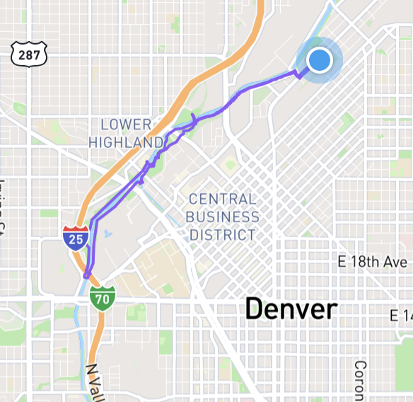 a map of downtown Denver, centering the central business district, with the word Denver in bold in the bottom right, and a purple line trailing along a river south-east and back about 6 miles along the river