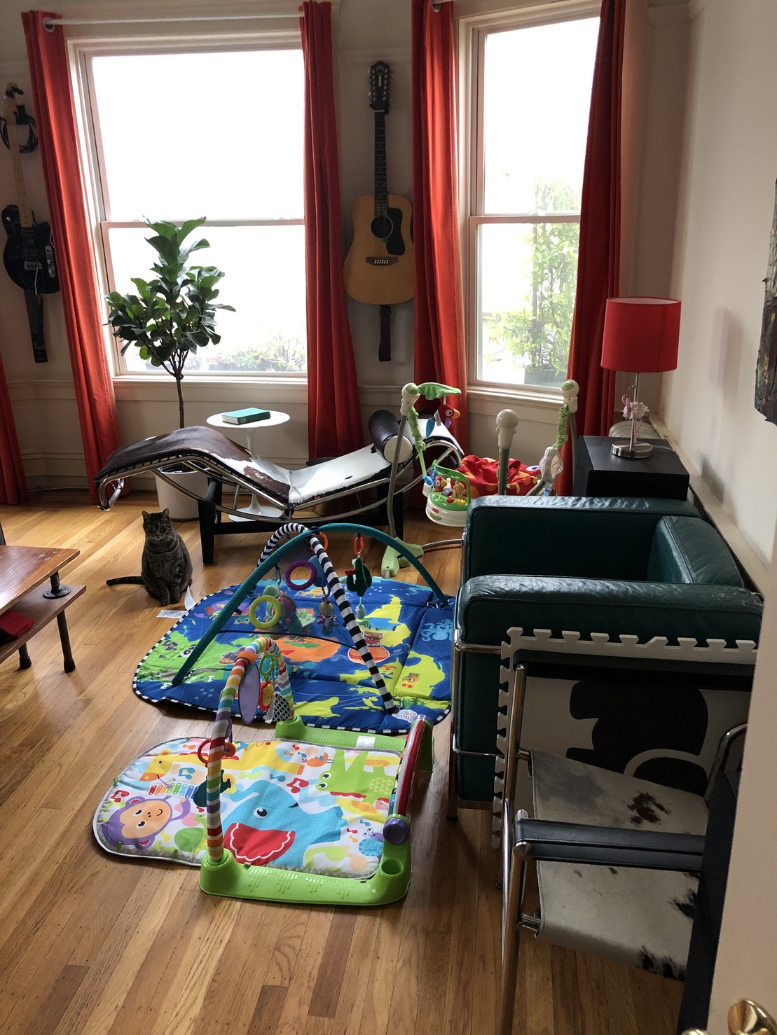 The living room is being taken over by baby distracting devices.