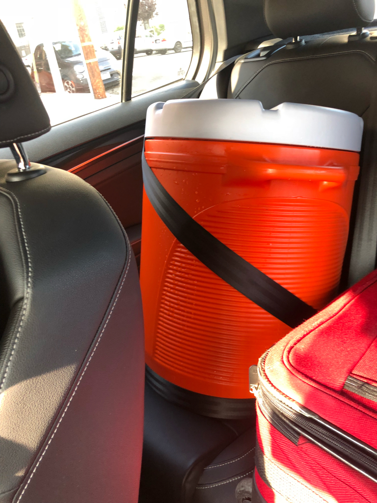 Water cooler seat-belted into the back seat.