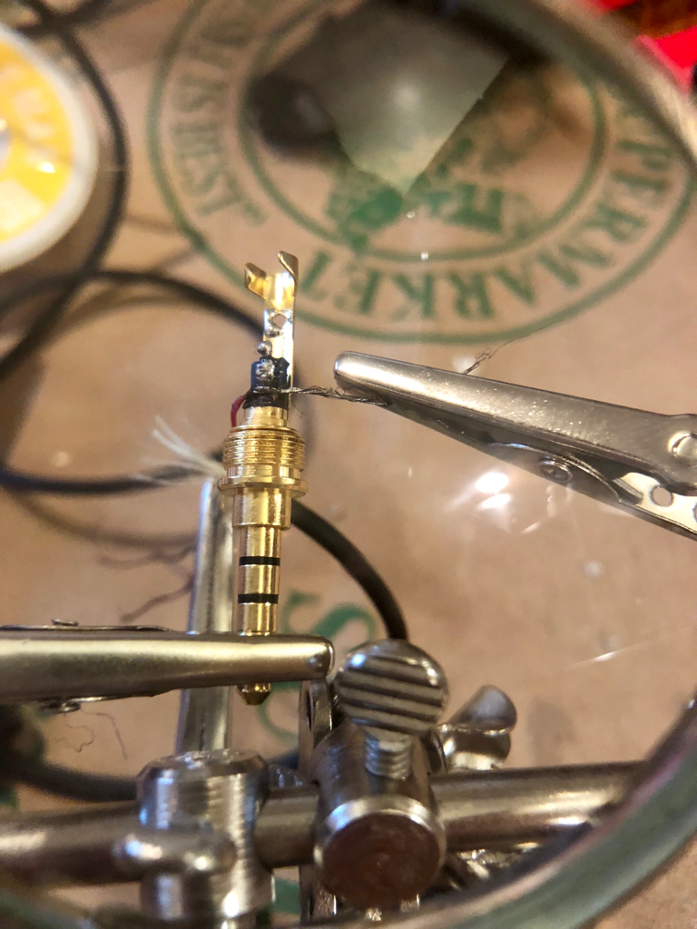 Soldering the right headphone signal to a new headphone jack tip.